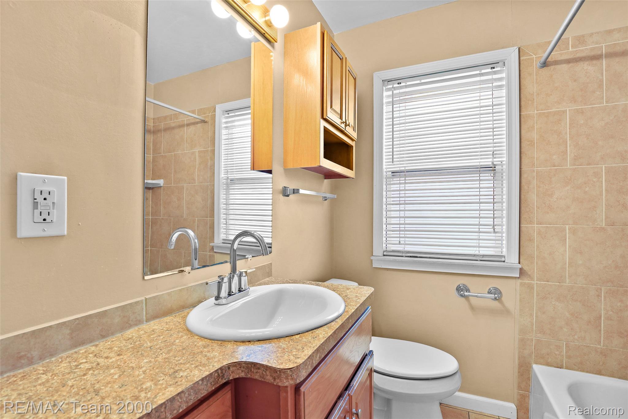 3130 Chestnut Street Dearborn, MI 48124 - Photo 12 of 30 Bathroom featuring a vanity with an integrated sink, a large mirror, and a window with blinds