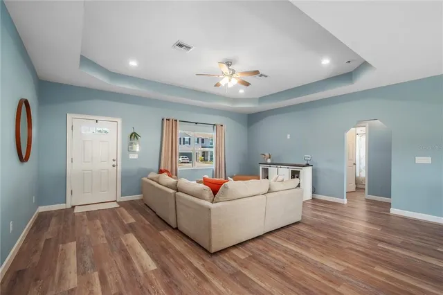 a living room with furniture and a wooden floor