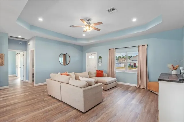 a living room with furniture and a chandelier
