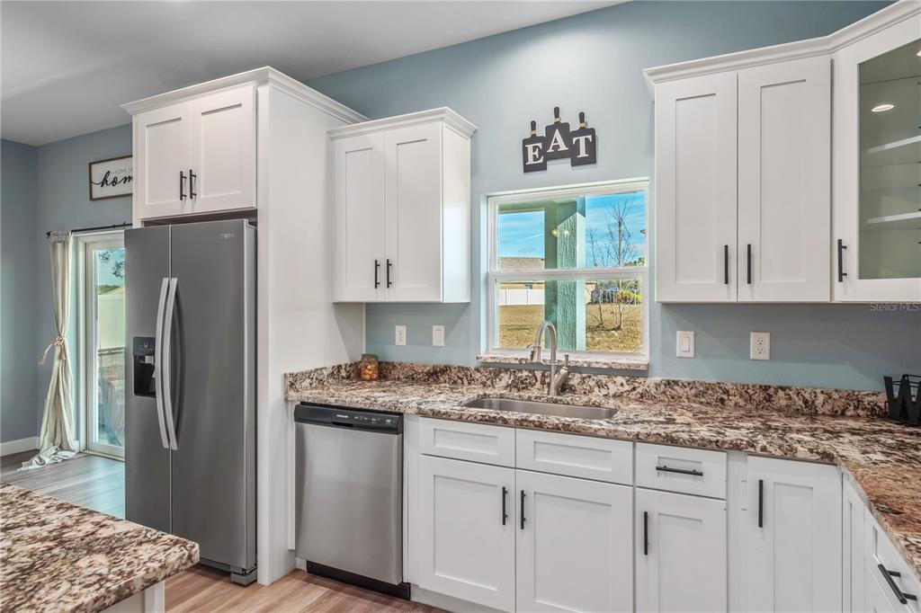 2839 Northeast 43rd Road Ocala, FL 34470 - Photo 17 of 50 a kitchen with stainless steel appliances granite countertop a refrigerator sink and cabinets