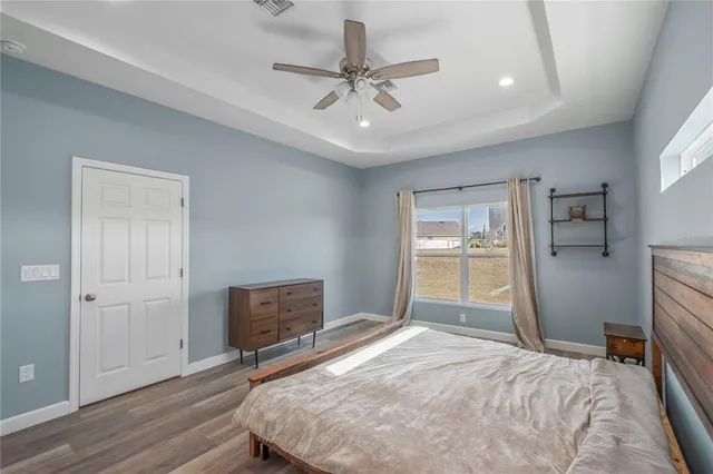 a bedroom with a bed and a ceiling fan