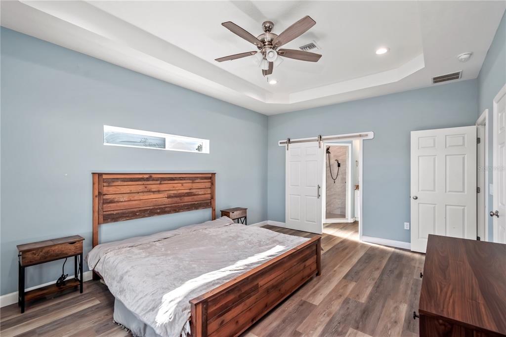 2839 Northeast 43rd Road Ocala, FL 34470 - Photo 24 of 50 a bedroom with a bed and a ceiling fan