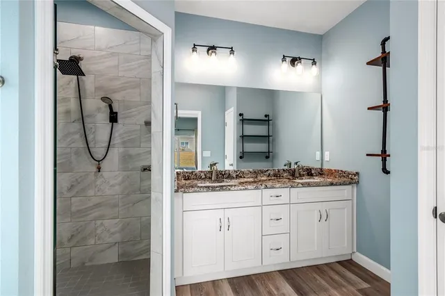 a bathroom with a granite countertop sink a mirror and a