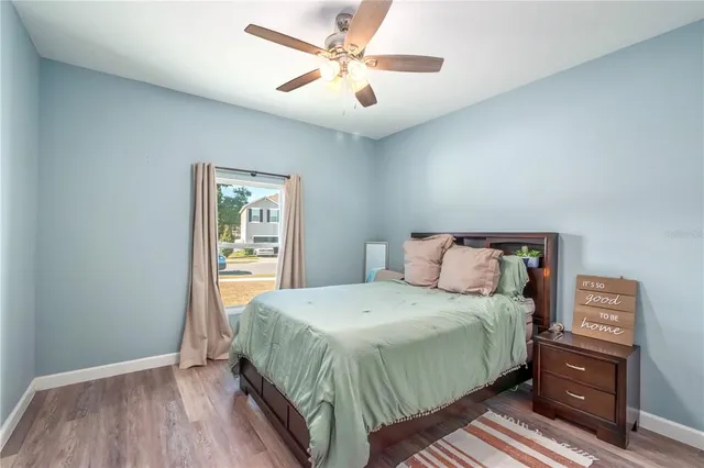 a large bed sitting in a bedroom and wooden floor