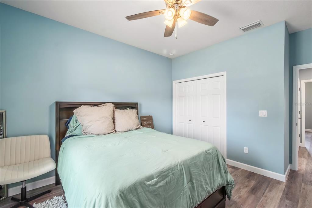 2839 Northeast 43rd Road Ocala, FL 34470 - Photo 32 of 50 a large bed sitting in a bedroom and wooden floor