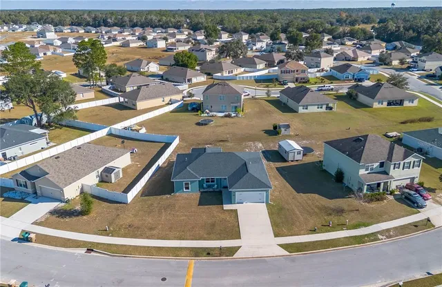 an aerial view of a house with a swimming pool
