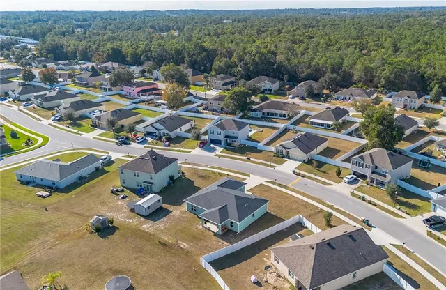 an aerial view of residential houses and outdoor space