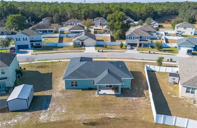 an aerial view of residential houses with outdoor space