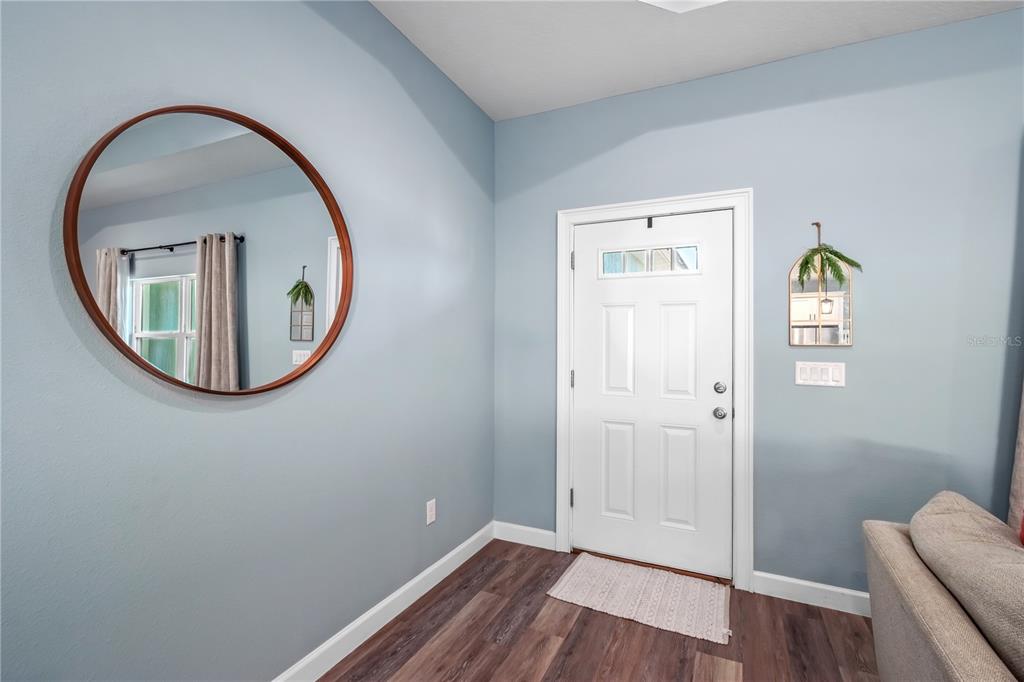 2839 Northeast 43rd Road Ocala, FL 34470 - Photo 10 of 50 an entryway with wooden floor and mirror