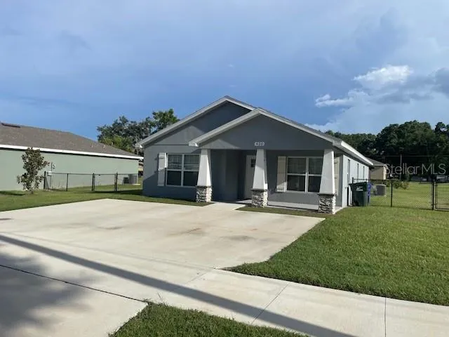 a front view of a house with yard and green space