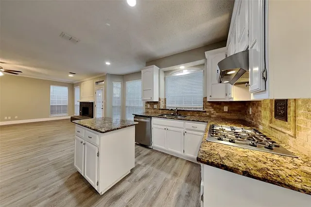 a kitchen with a sink stove and wooden cabinets