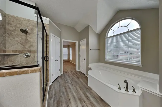 a bathroom with a bathtub and a shower