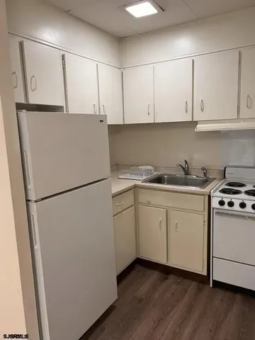 a white refrigerator freezer sitting in a kitchen
