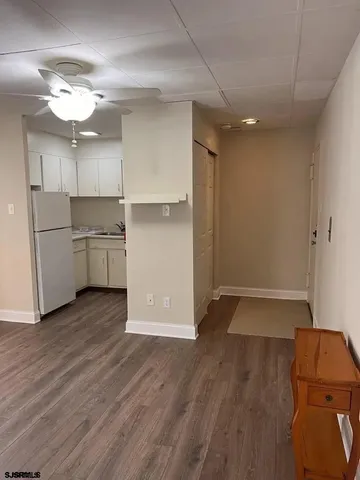 a room with wooden floors and chandelier