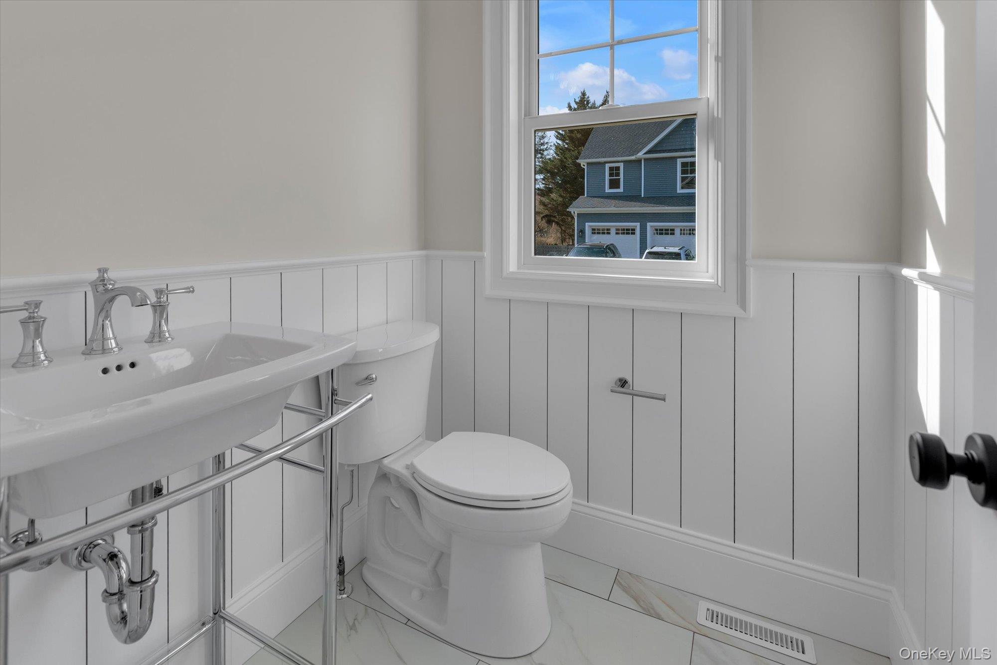 44 North Woodhull Road Huntington, NY 11743 - Photo 14 of 26 Half bath featuring wainscoting and marble finish floors