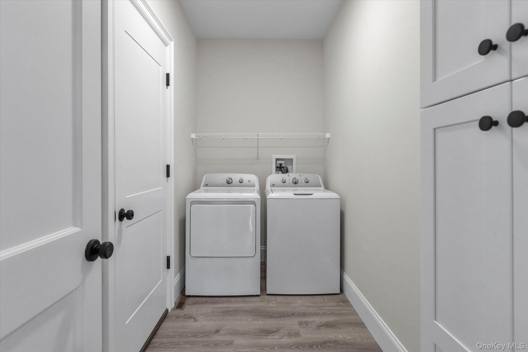 44 North Woodhull Road Huntington, NY 11743 - Photo 15 of 26 Laundry room with light wood-type flooring and washing machine and clothes dryer