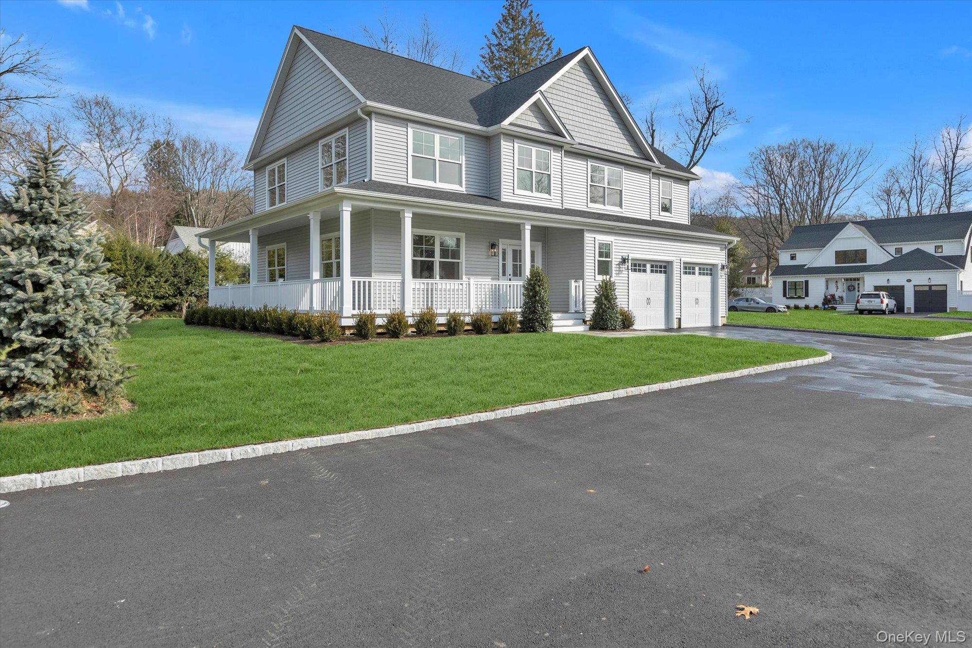 44 North Woodhull Road Huntington, NY 11743 - Photo 2 of 26 View of front of house featuring covered porch, a front lawn, asphalt driveway, and roof with shingles