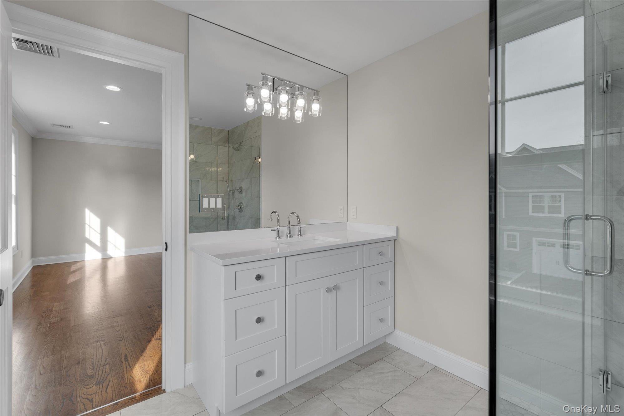 44 North Woodhull Road Huntington, NY 11743 - Photo 22 of 26 Bathroom with a shower stall, vanity, crown molding, and recessed lighting