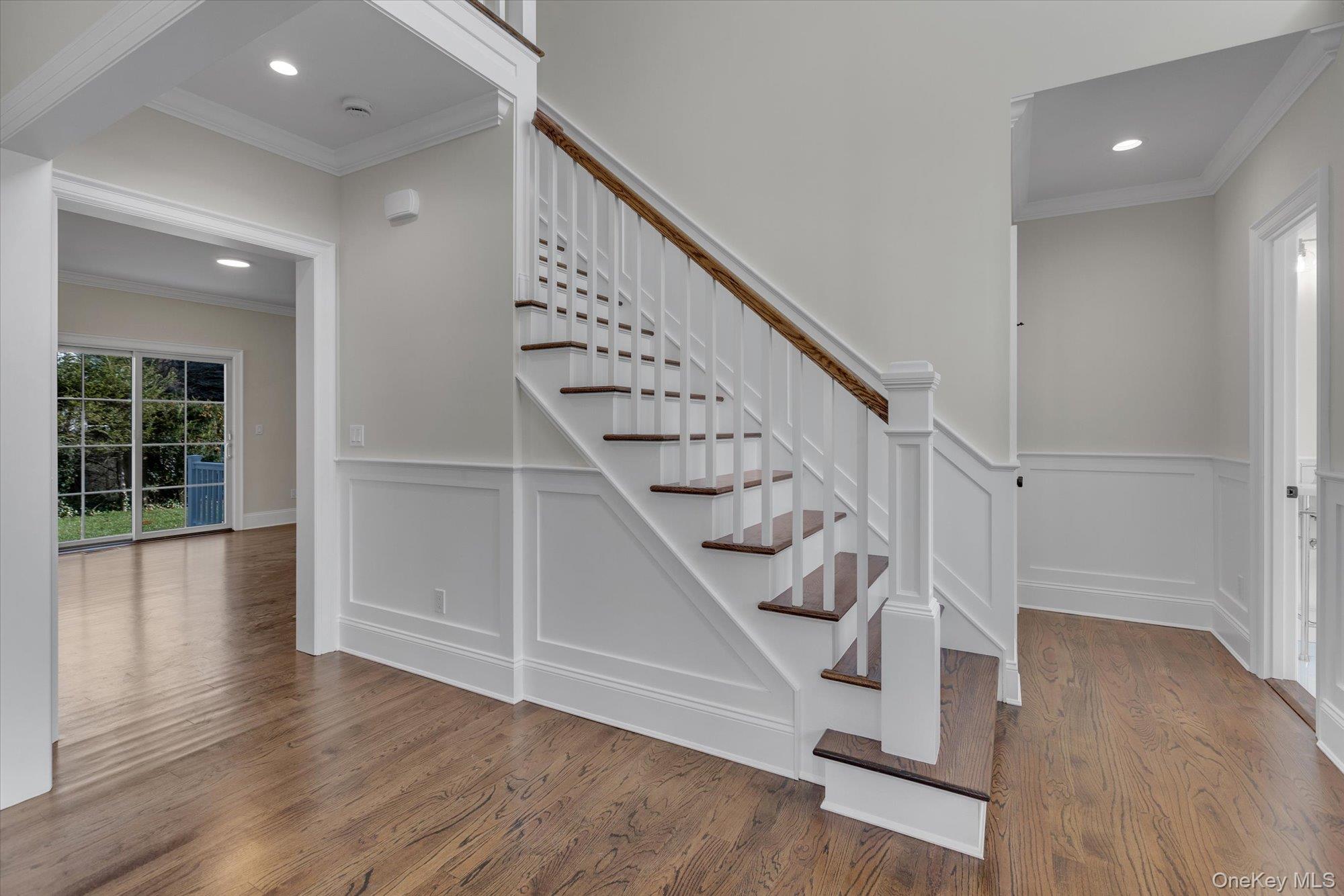 44 North Woodhull Road Huntington, NY 11743 - Photo 4 of 26 Staircase featuring ornamental molding, wood finished floors, wainscoting, and recessed lighting