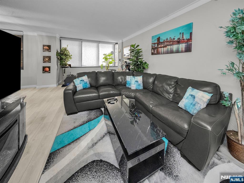 316 Prospect Avenue, Unit 8D Hackensack, NJ 07601 - Photo 2 of 17 a living room with furniture and a flat screen tv