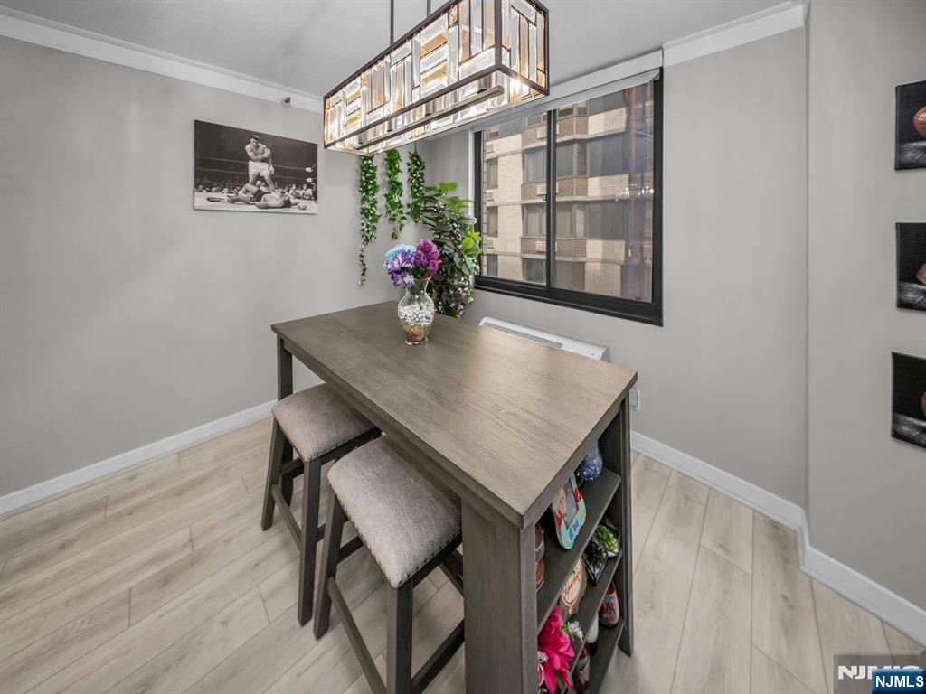 316 Prospect Avenue, Unit 8D Hackensack, NJ 07601 - Photo 6 of 17 a view of a dining room with furniture and wooden floor