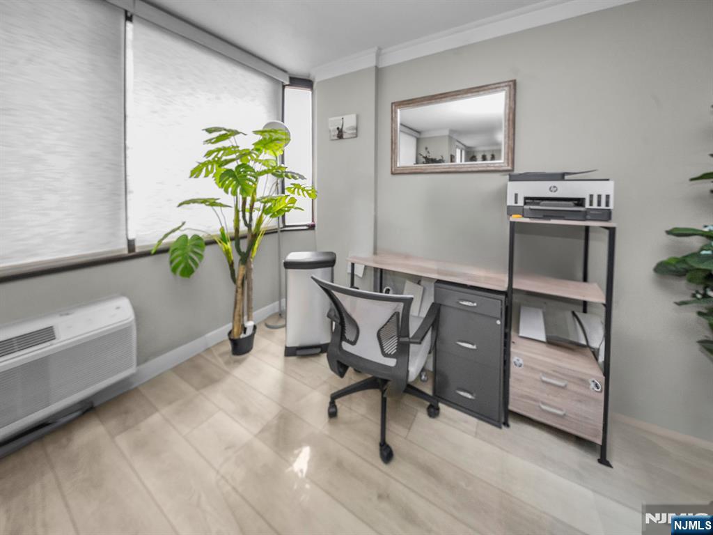 316 Prospect Avenue, Unit 8D Hackensack, NJ 07601 - Photo 7 of 17 a workspace with furniture and a potted plant