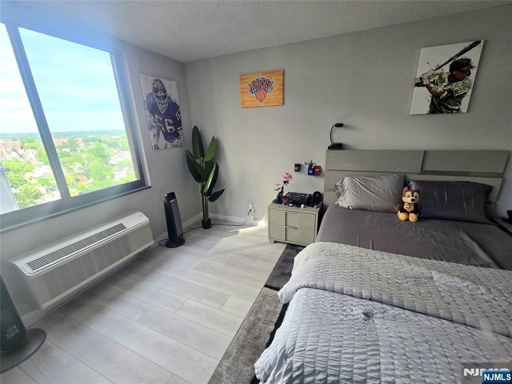 316 Prospect Avenue, Unit 8D Hackensack, NJ 07601 - Photo 8 of 17 a living room with furniture and a potted plant