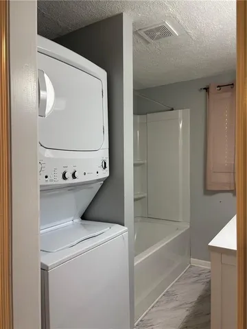 a bathroom with a tub and shower