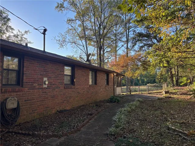 a backyard of a house with barbeque oven