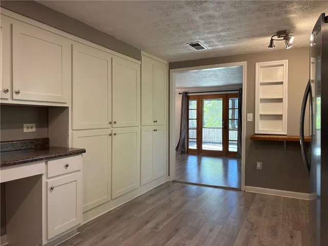 wooden floor in an empty room with a fireplace