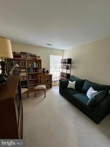 a living room with furniture and a lamp