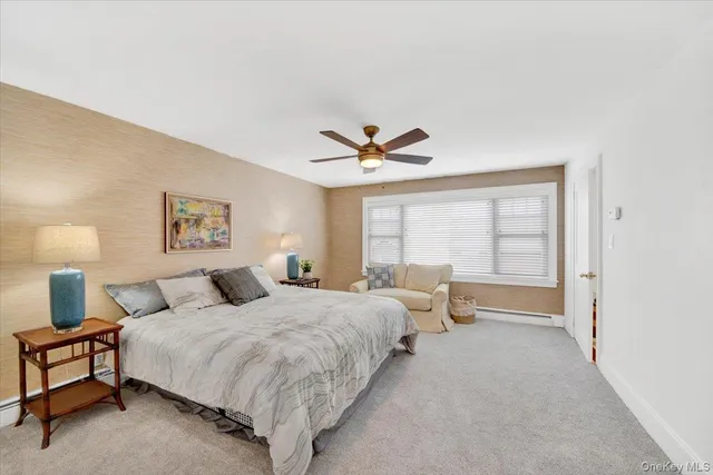 a spacious bedroom with a bed and a large window