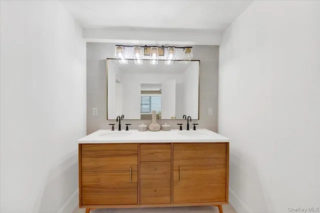 a bathroom with a sink vanity and a mirror