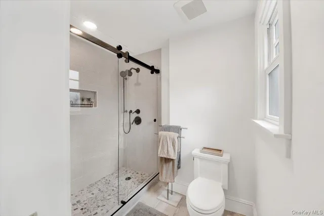 a white toilet sitting next to a bathroom sink