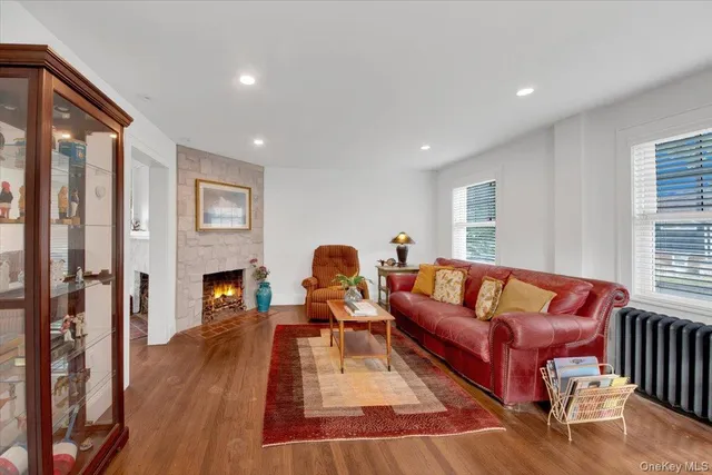 a living room with furniture fireplace and a window