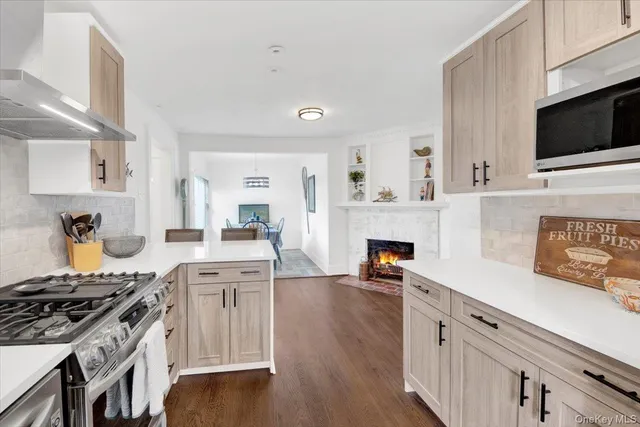a kitchen with stainless steel appliances a stove microwave and cabinets