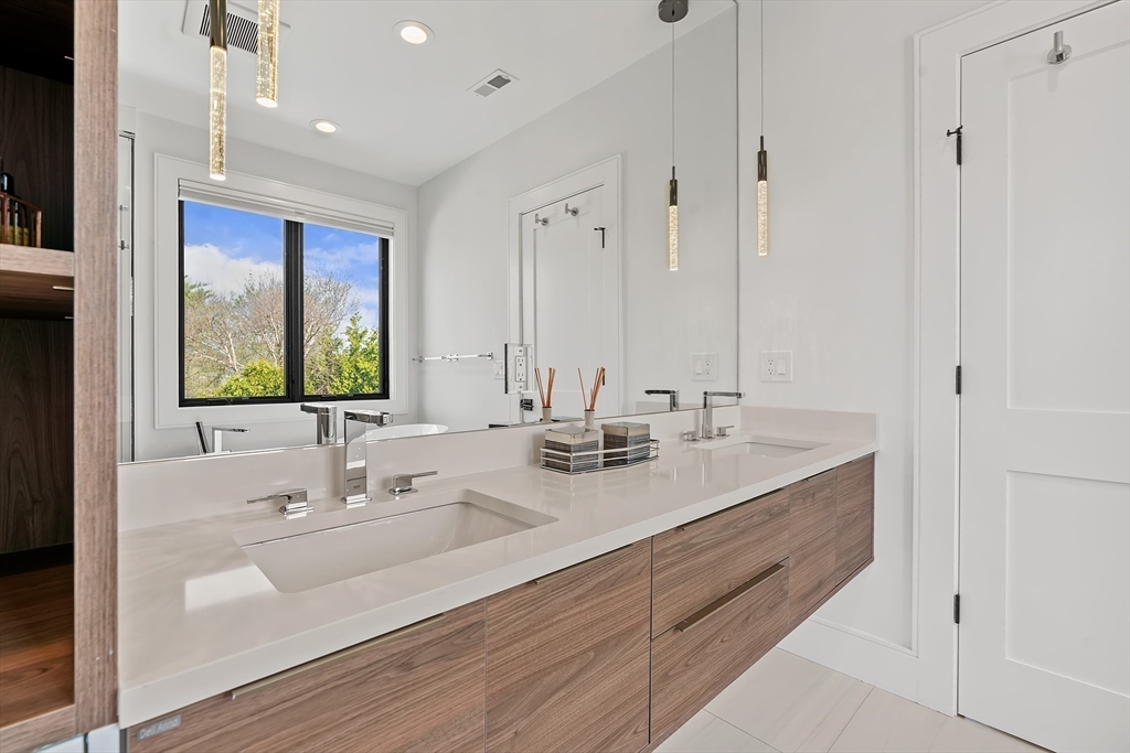 9 Whittlesey Road Newton, MA 02459 - Photo 14 of 33 a bathroom with double vanity sinks and a mirror