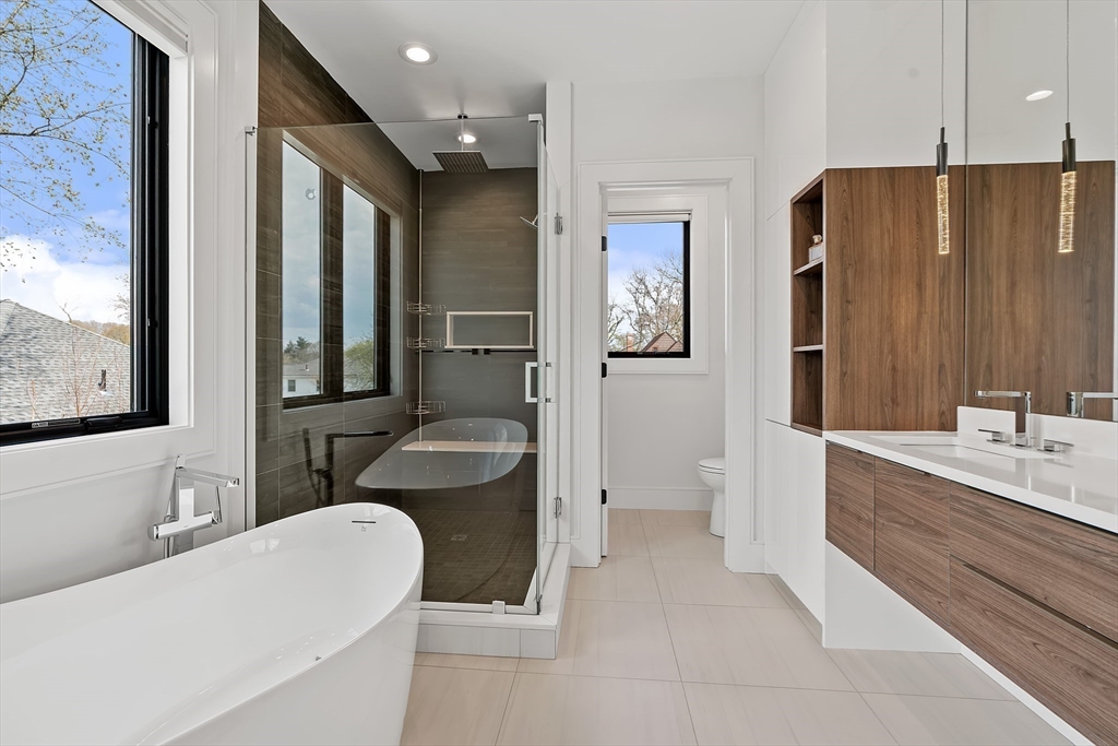 9 Whittlesey Road Newton, MA 02459 - Photo 15 of 33 a bathroom with a granite countertop sink and a large mirror
