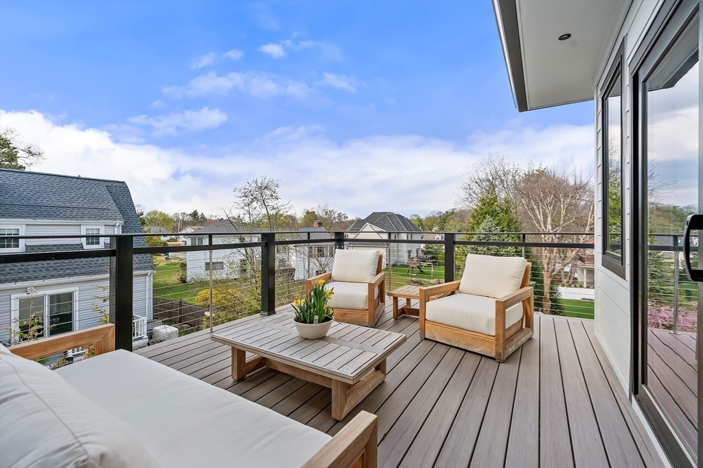 9 Whittlesey Road Newton, MA 02459 - Photo 17 of 33 a view of a balcony with wooden floor and outdoor seating