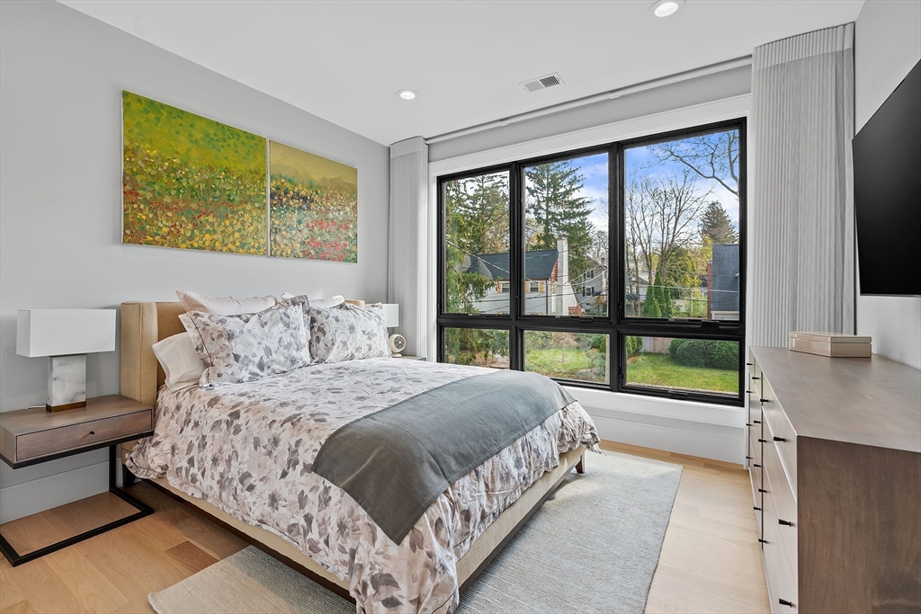 9 Whittlesey Road Newton, MA 02459 - Photo 18 of 33 a bedroom with a large bed and a large window