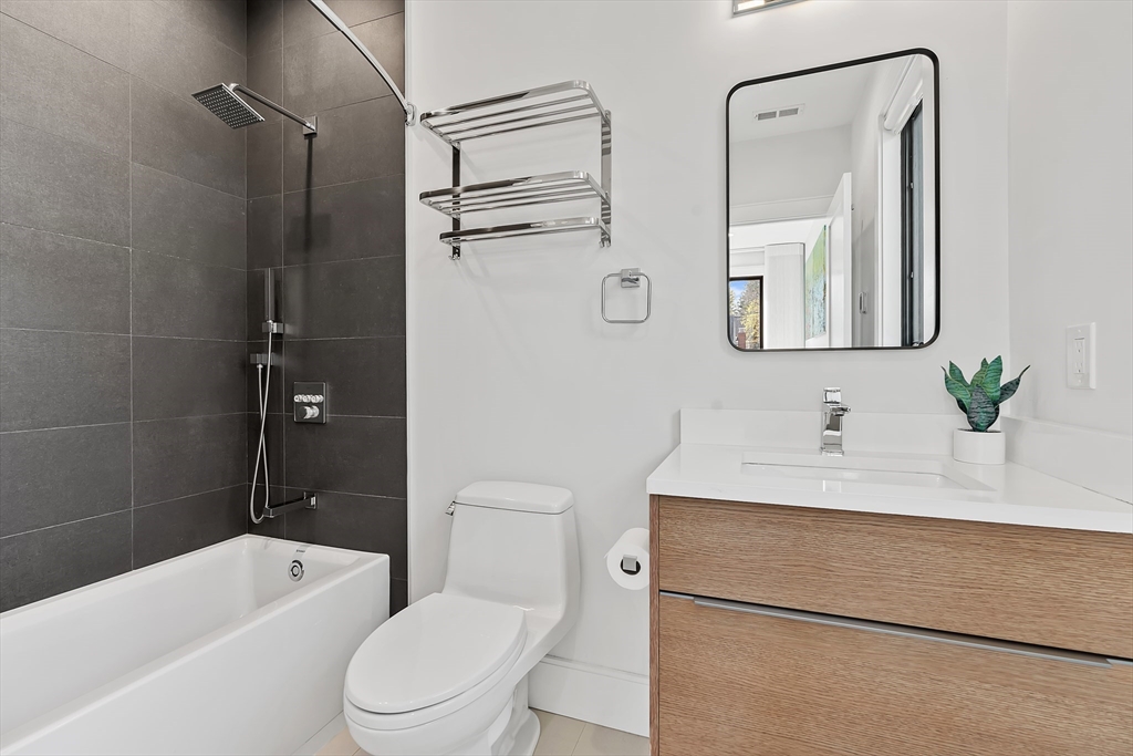 9 Whittlesey Road Newton, MA 02459 - Photo 19 of 33 a bathroom with a sink toilet vanity tub and shower