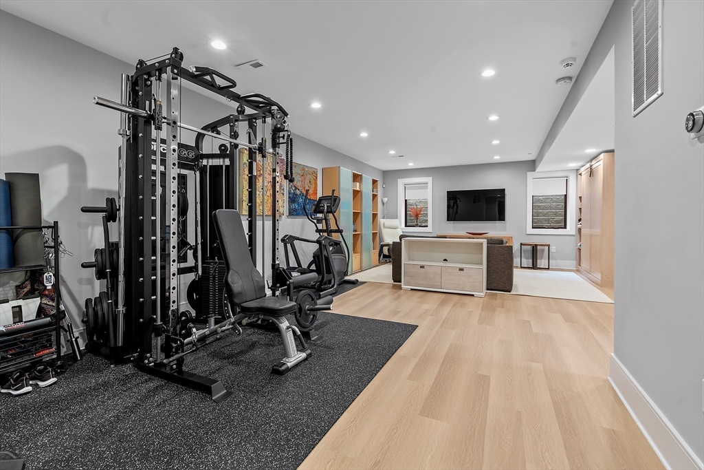 9 Whittlesey Road Newton, MA 02459 - Photo 28 of 33 a view of a room with gym equipment and a flat screen tv