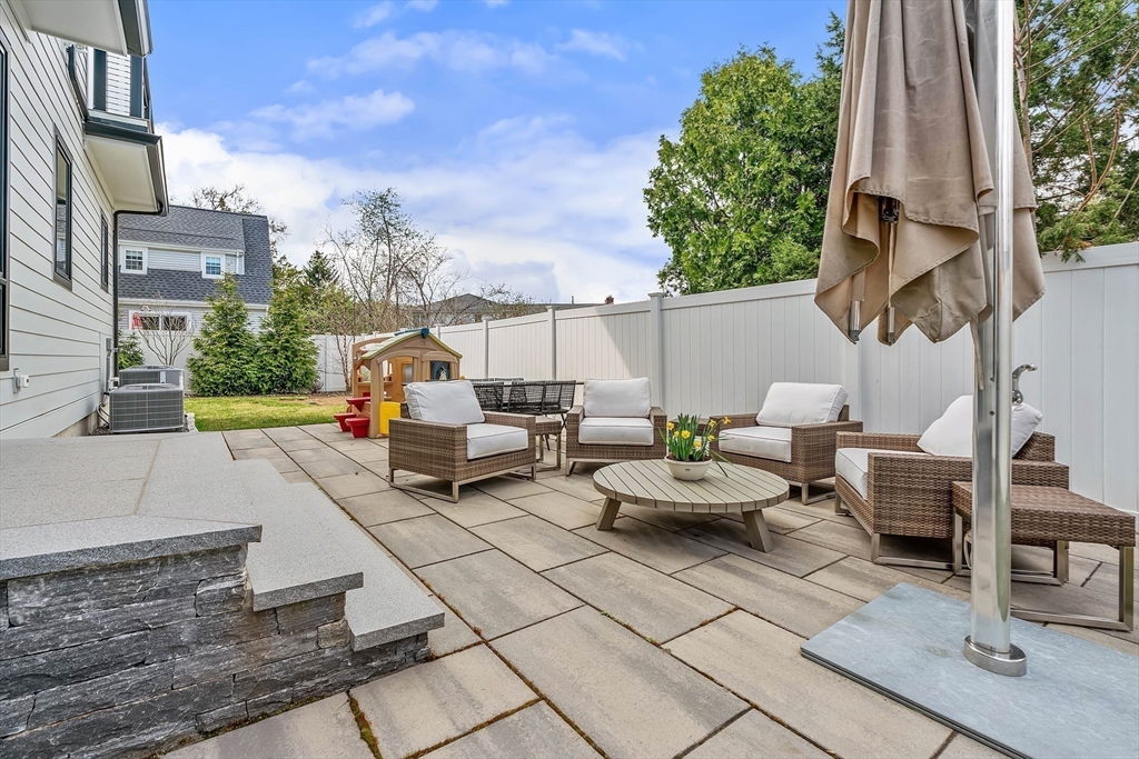 9 Whittlesey Road Newton, MA 02459 - Photo 31 of 33 a backyard of a house with barbeque oven table and chairs
