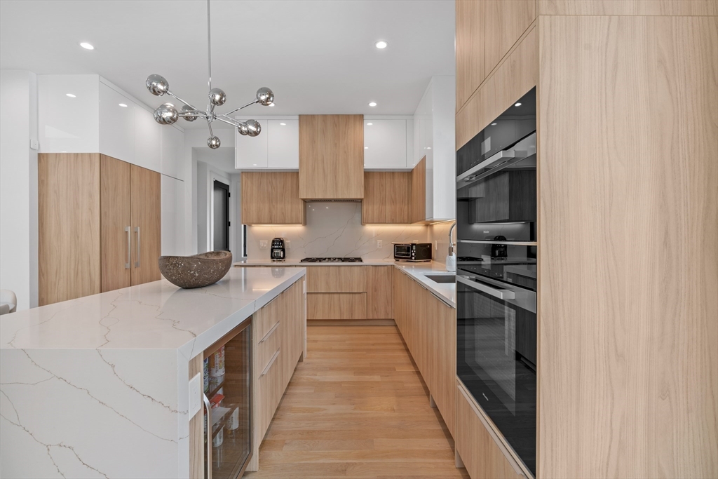9 Whittlesey Road Newton, MA 02459 - Photo 7 of 33 a kitchen with stainless steel appliances a refrigerator and a stove top oven