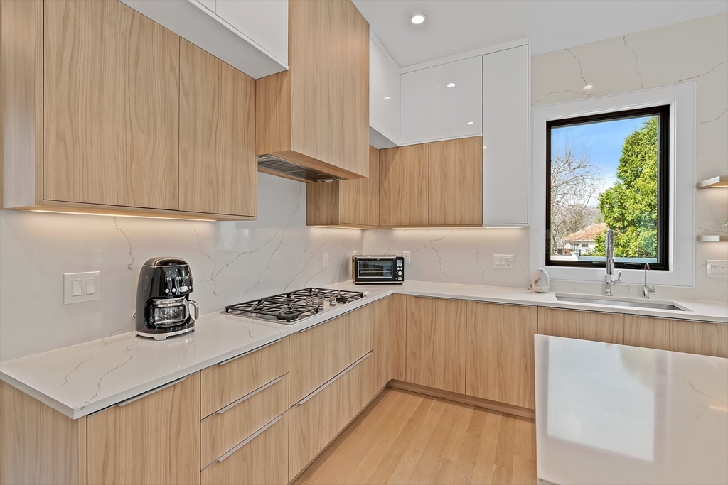 9 Whittlesey Road Newton, MA 02459 - Photo 8 of 33 a kitchen with granite countertop a sink a stove and cabinets