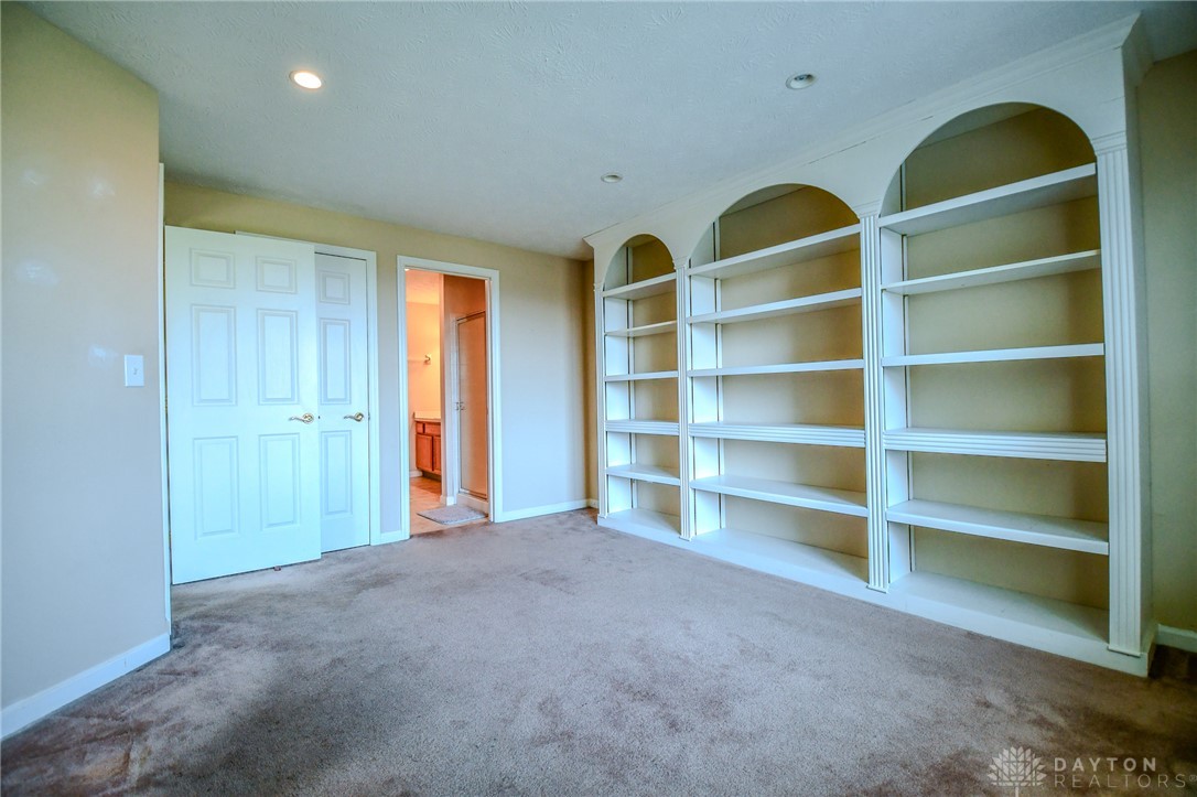 3915 East Summit Ridge Drive Beavercreek, OH 45430 - Photo 38 of 47 This versatile room features custom built-in bookshelves, offering both style and functionality.