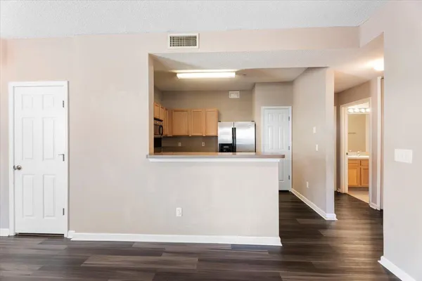 a view of a hallway with wooden floor