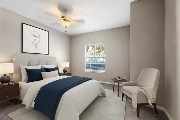 a bedroom with bed and a chair