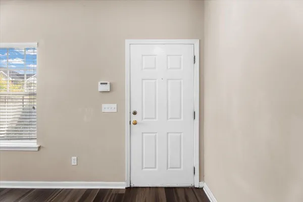 a view of front door with wooden floor