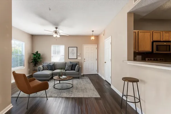 a living room with furniture and a wooden floor